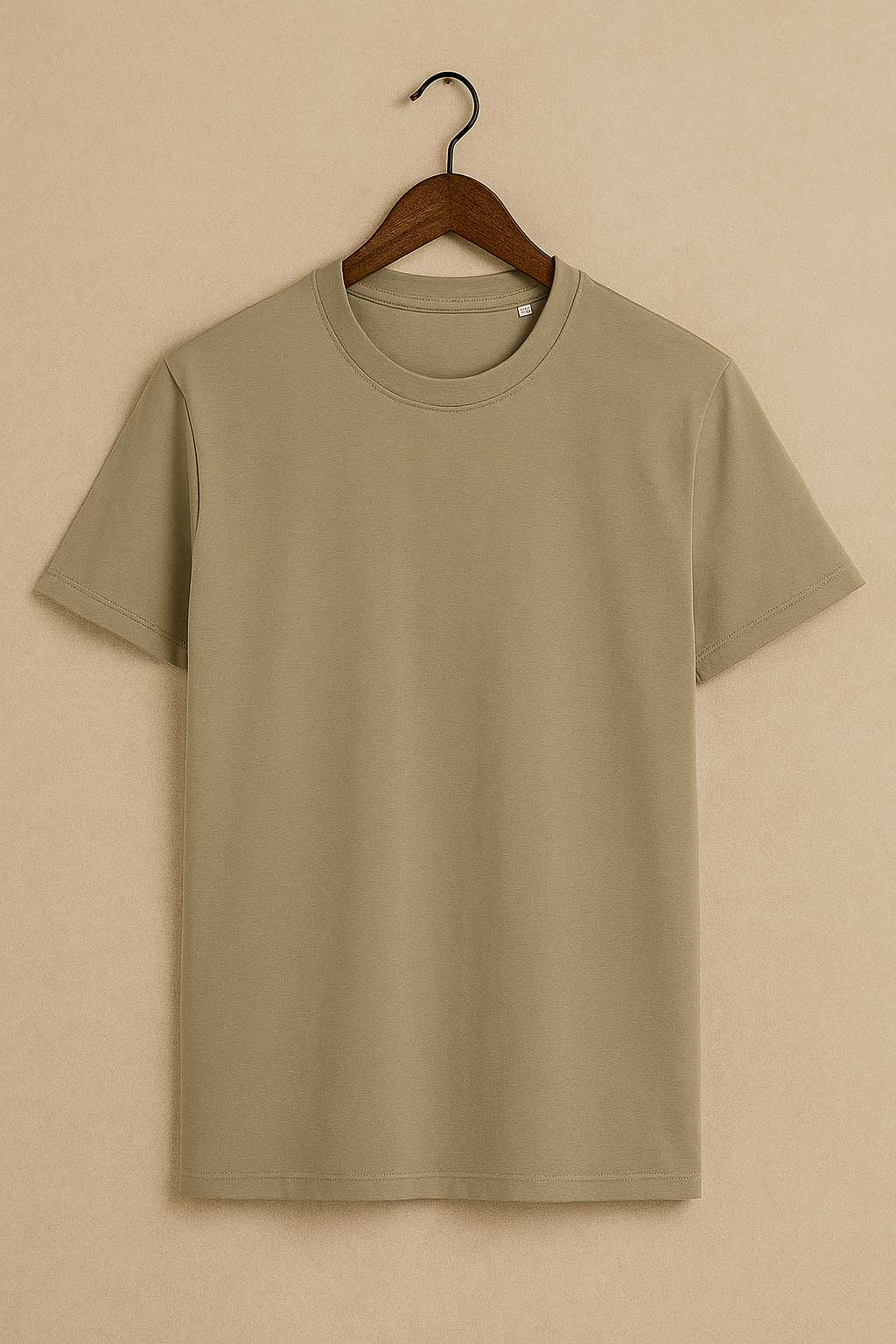 Beige t-shirt on a wooden hanger against a beige background