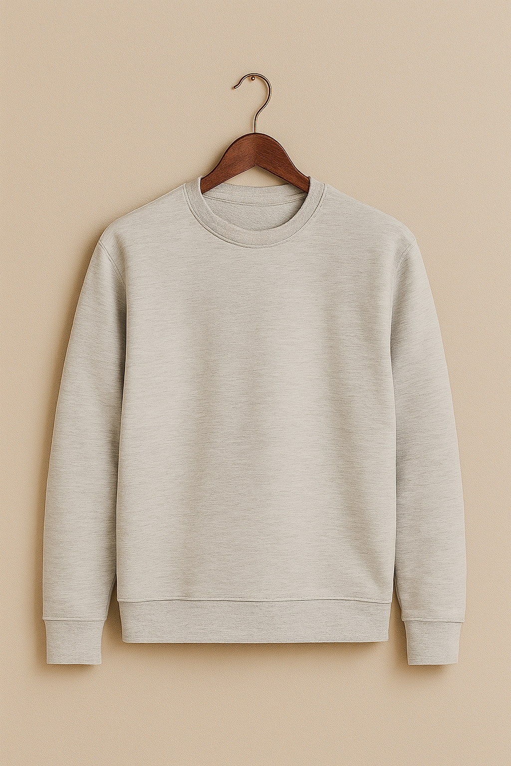 Gray sweatshirt on a wooden hanger against a beige background