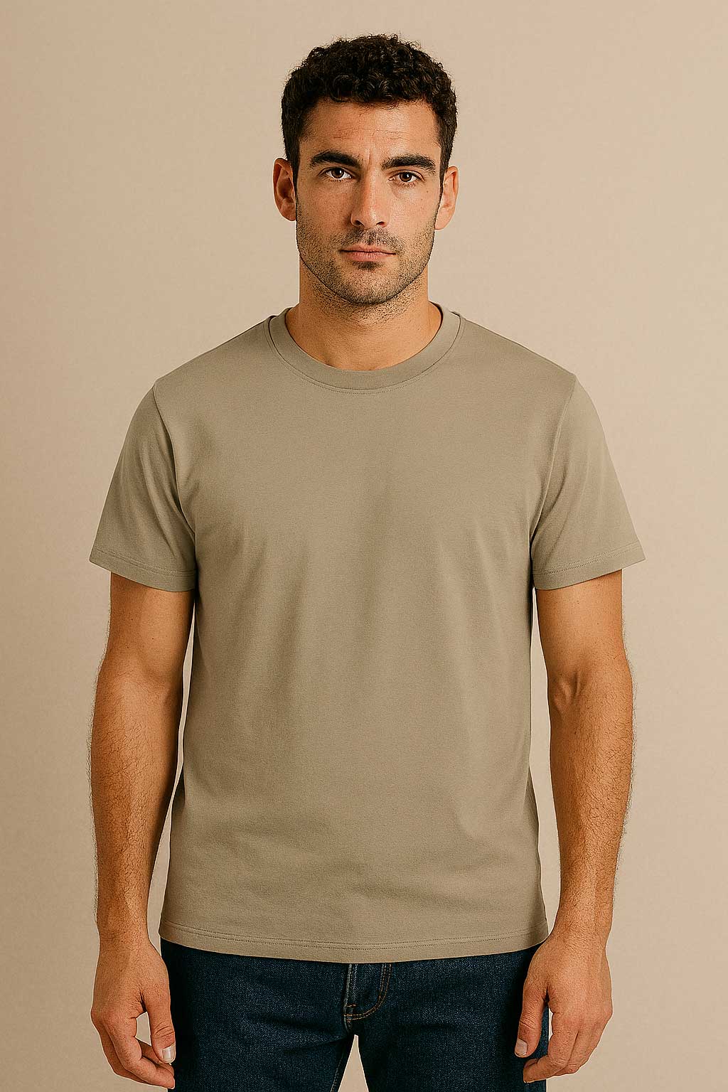 Man wearing a plain beige t-shirt against a beige background