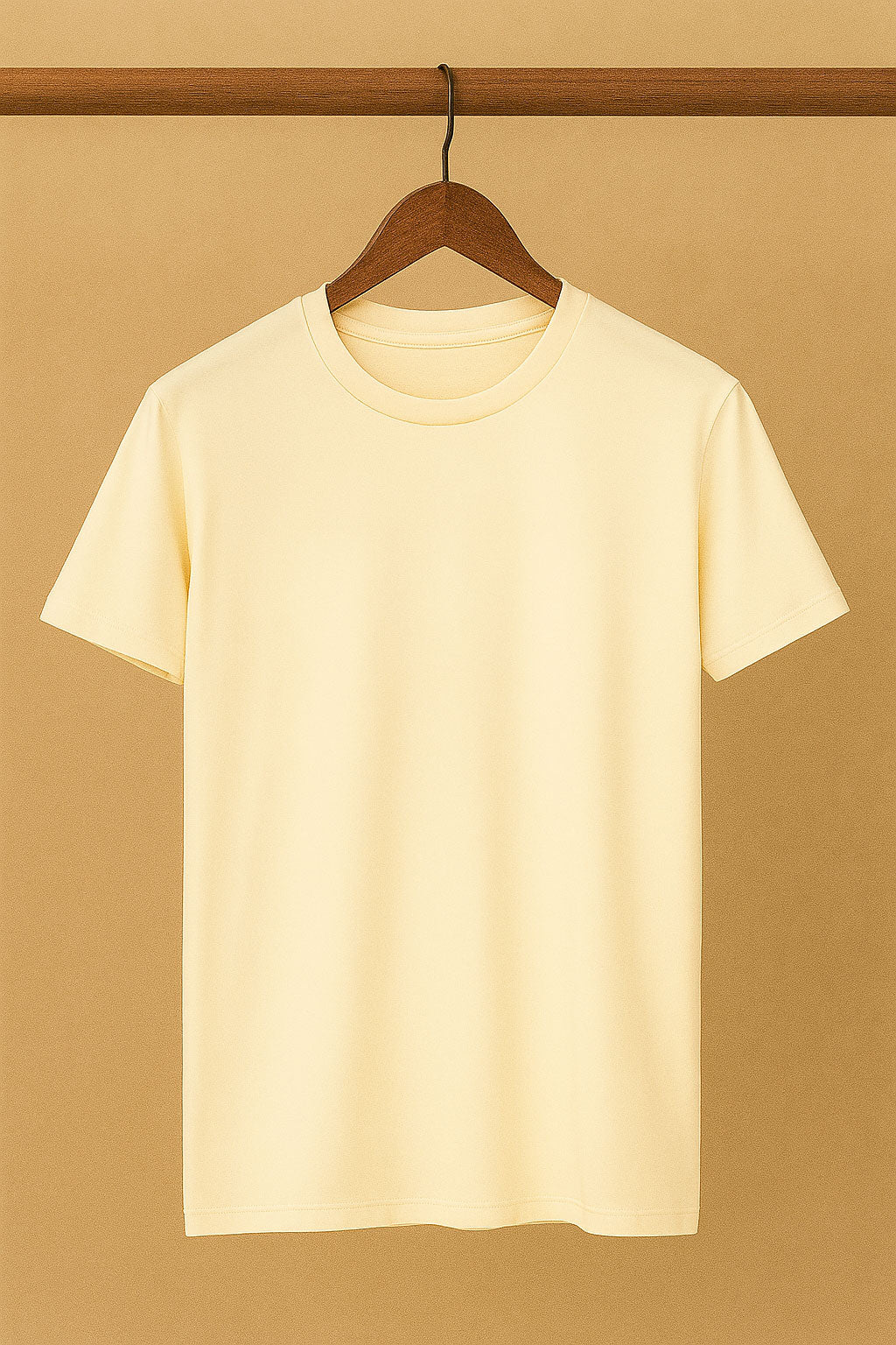 Beige t-shirt on a wooden hanger against a beige background